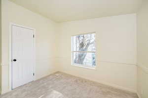 Empty room with baseboards and carpet