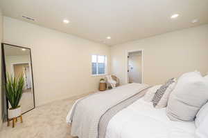 Bedroom with baseboards, visible vents, recessed lighting, and light colored carpet