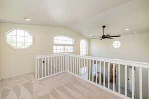 Hallway featuring carpet floors, recessed lighting, and lofted ceiling