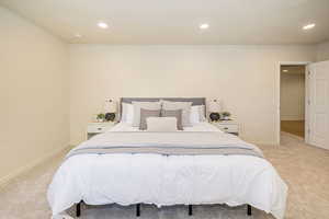 Bedroom with recessed lighting and light carpet