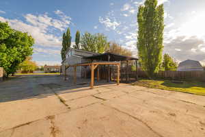 View of patio / terrace with fence and concrete driveway