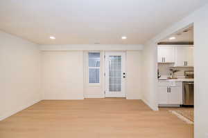 Interior space with light wood-style floors and recessed lighting