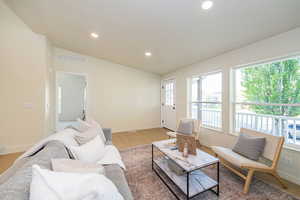 Living room featuring baseboards, visible vents, and a wealth of natural light
