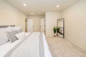 Bedroom with recessed lighting, baseboards, light colored carpet, and visible vents