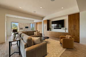 Living area with wood finished floors, recessed lighting, and baseboards