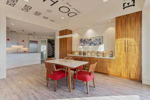Dining room featuring light wood-type flooring and recessed lighting