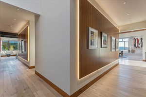 Hallway featuring recessed lighting, light wood-style floors, and baseboards