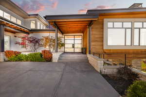 Doorway to property featuring stucco siding