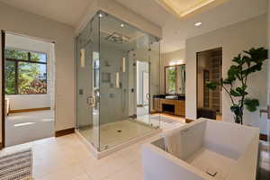 Bathroom with a soaking tub, a stall shower, baseboards, recessed lighting, and tile patterned flooring