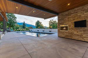 View of swimming pool featuring a patio and a mountain view