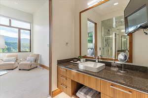 Bathroom with a shower stall, plenty of natural light, vanity, and a mountain view