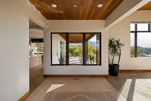 Empty room featuring wood finished floors, baseboards, recessed lighting, and wood ceiling