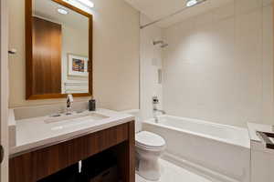 Full bathroom featuring toilet, bathing tub / shower combination, and vanity