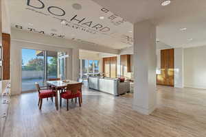 Dining space with light wood-style floors and baseboards