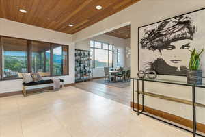 Interior space featuring tile patterned floors, wooden ceiling, baseboards, and recessed lighting