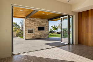 Doorway featuring wood ceiling, wood walls, and wood finished floors