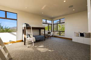 Bedroom featuring baseboards, recessed lighting, carpet floors, and a mountain view
