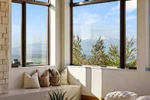 Sunroom featuring plenty of natural light and a mountain view