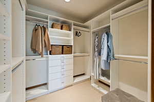Spacious closet with light colored carpet
