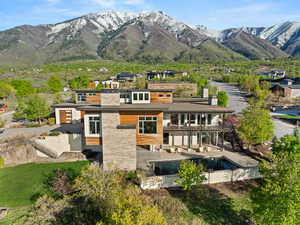 Rear view of house with stairway and a mountain view