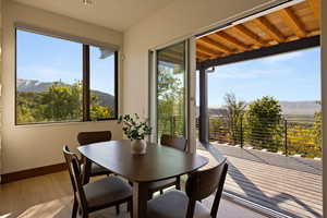 Sunroom / solarium with a mountain view, baseboards, and wood-type flooring