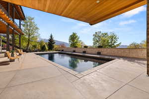 View of pool featuring a mountain view and a patio area