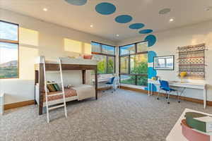 Carpeted bedroom with recessed lighting and baseboards