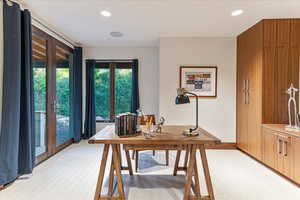 Office space featuring light colored carpet, baseboards, and recessed lighting
