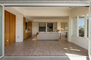 Living room featuring stairs, wood finished floors, and baseboards