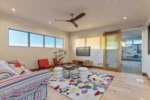 Living area featuring recessed lighting, visible vents, a ceiling fan, and wood finished floors