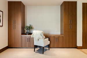 Living area with light carpet and baseboards