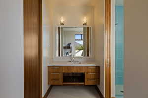 Bathroom with vanity, a shower, and baseboards
