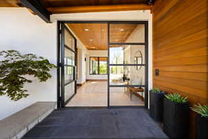 View of exterior entry featuring stucco siding