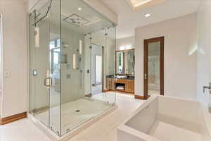Bathroom featuring baseboards, recessed lighting, vanity, tile patterned floors, and a stall shower