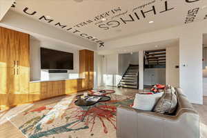 Interior space with recessed lighting, stairway, baseboards, and wood finished floors