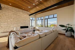 Living room featuring wood ceiling, hardwood / wood-style flooring, baseboards, recessed lighting, and a fireplace