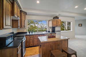 Downstairs full kitchen with island and walkout to the backyard