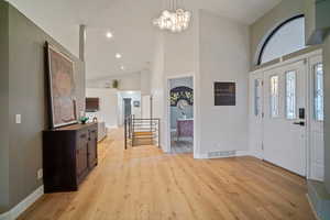 Beautiful entry with vaulted ceilings and wood floors