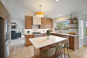 Spacious Kitchen with wood cabinets, stainless steel appliances, quartz countertops