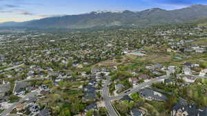 Birds eye view of property with a residential view and a mountain view