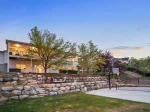 View of the back of the home and basketball court