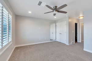 Unfurnished bedroom featuring carpet flooring, recessed lighting, baseboards, and visible vents