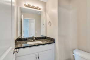 Bathroom featuring vanity and toilet
