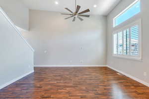 Unfurnished living room featuring plenty of natural light, ceiling fan, wood finished floors, and visible vents