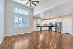 Kitchen with visible vents, dark wood-style flooring, dark countertops, ceiling fan, and appliances with stainless steel finishes