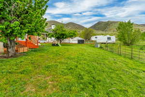 View of yard with a fenced backyard and a mountain view