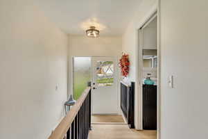 Corridor with light wood-style floors