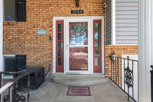 Entrance to property featuring brick siding
