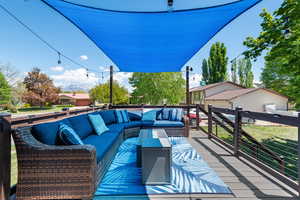 Wooden deck featuring outdoor lounge area