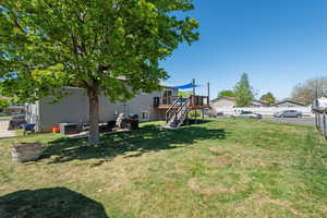 View of yard featuring a fenced backyard, a deck, and stairway